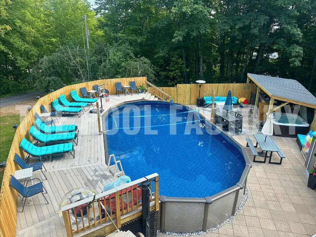 Modern oval above ground swimming pool with wood deck and lounge chairs