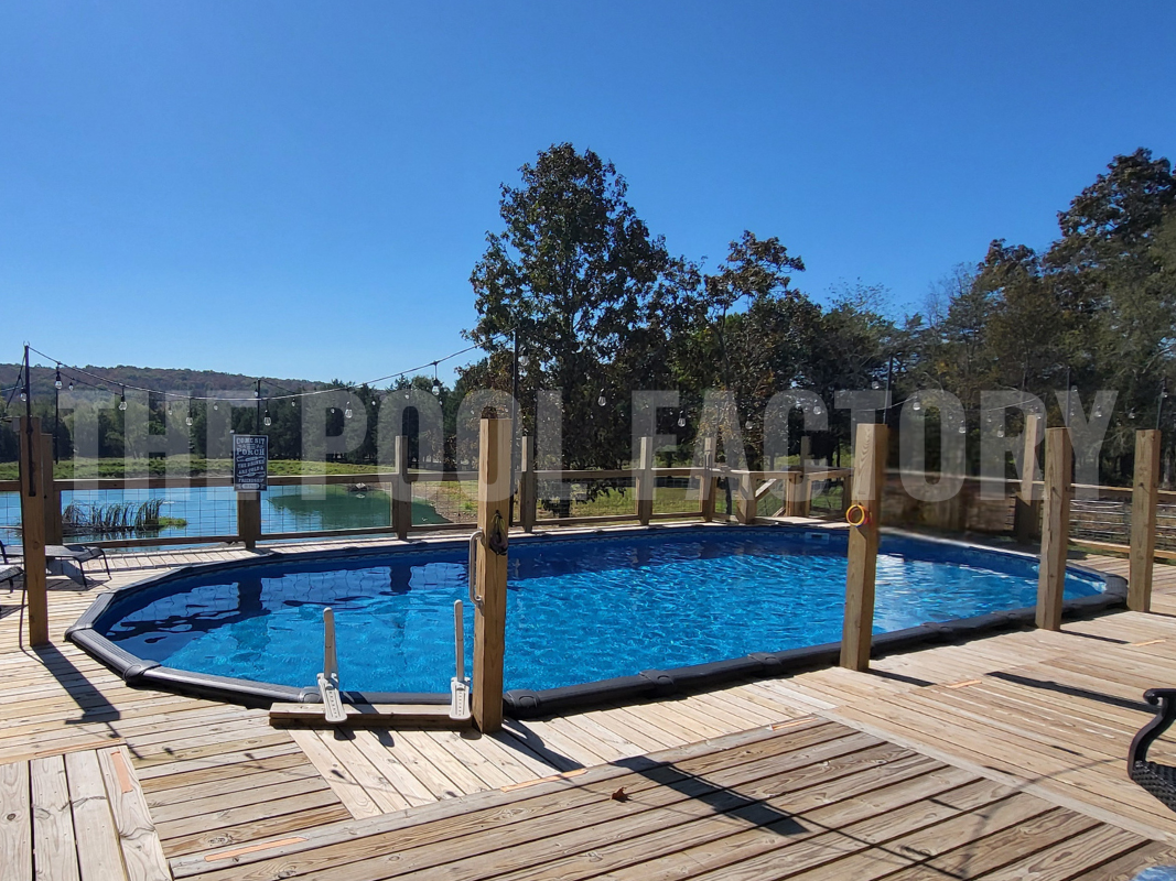 Semi-inground oval pool with lake view on a sunny clear day
