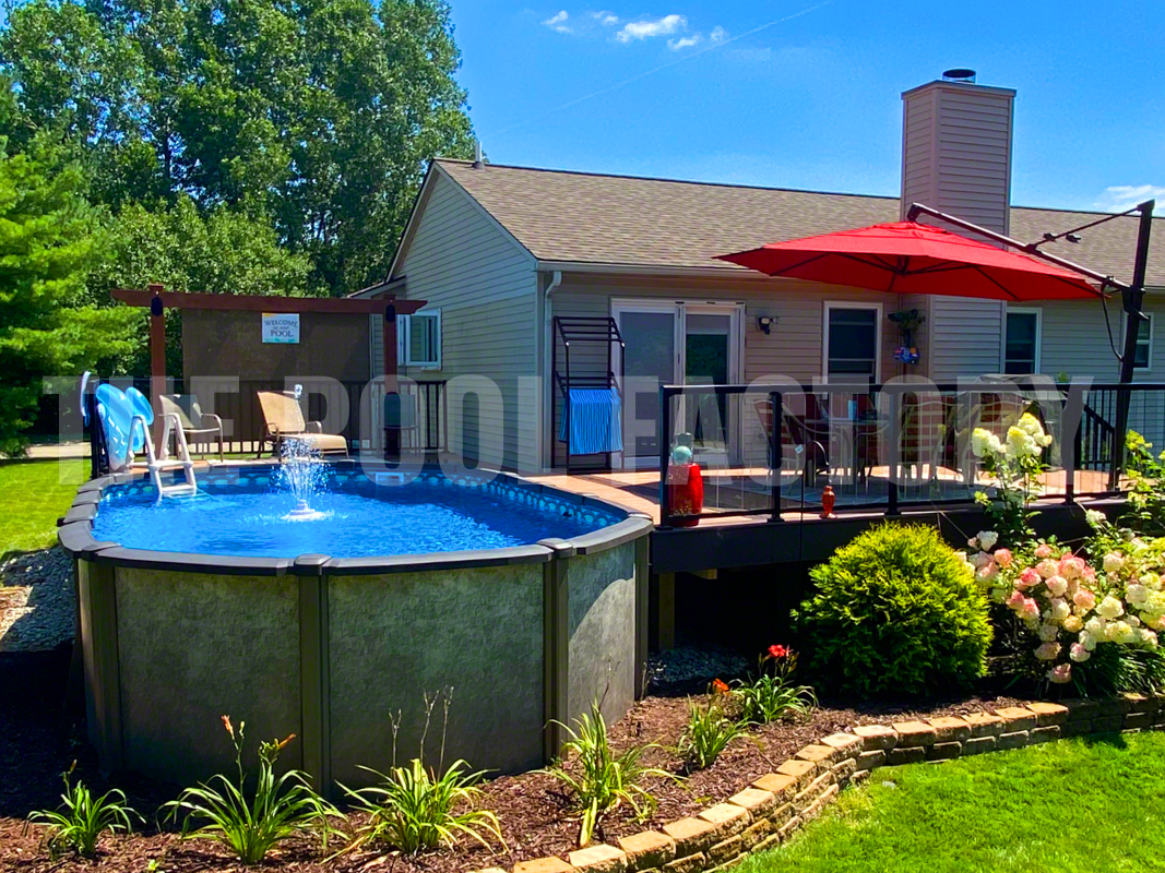 Above ground oval pool with sunny deck, plants, and flowers