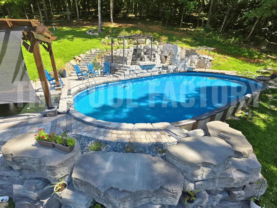 Oval saltwater pool surrounded by handcrafted stonework for a pathway and peaceful landscaped scenery