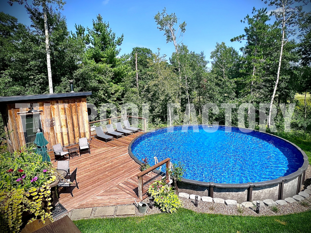 Round above ground saltwater pool with deck, surrounded by trees and greenery on a sunny day