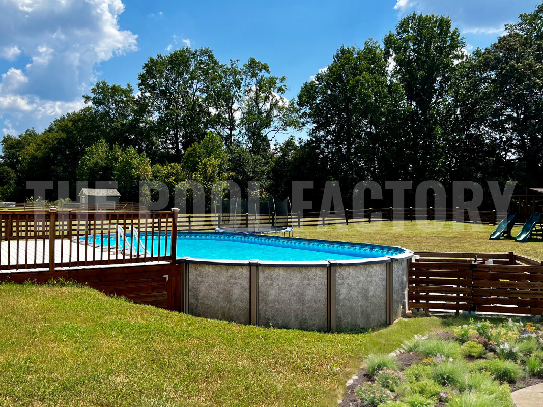 Above ground saltwater pool with deck and surrounding greenery