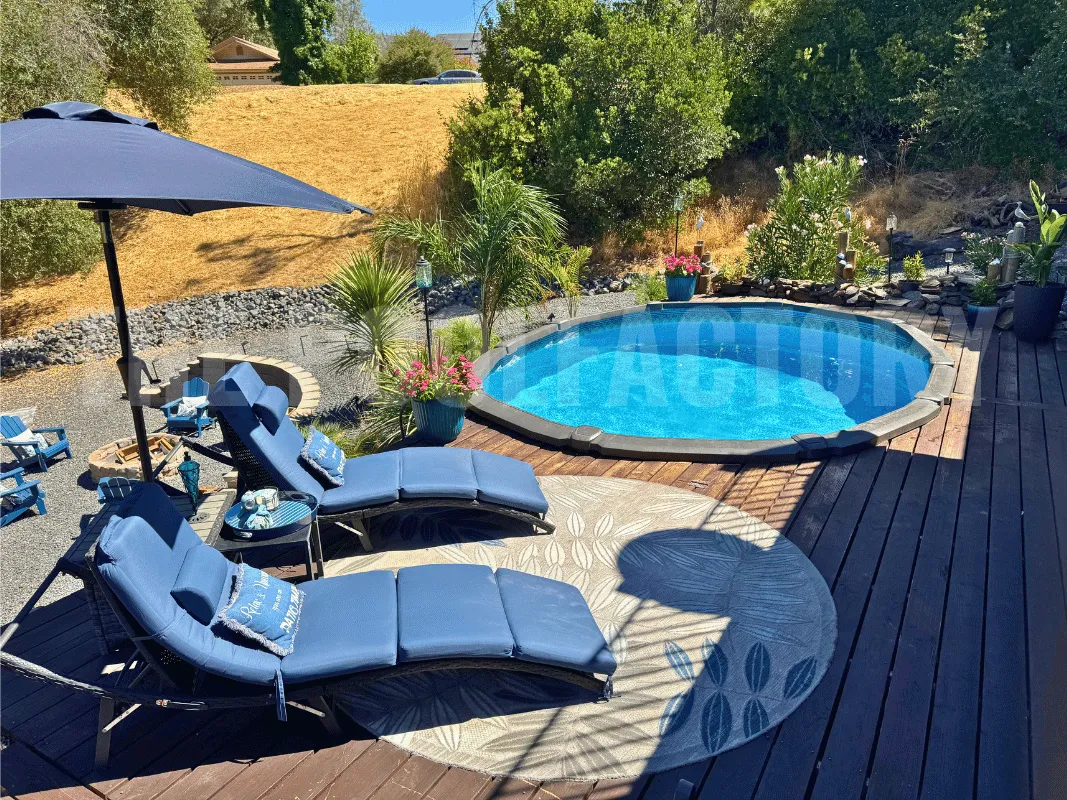 Oval above ground pool with partial deck and comfortable lounge chairs for relaxing outdoors