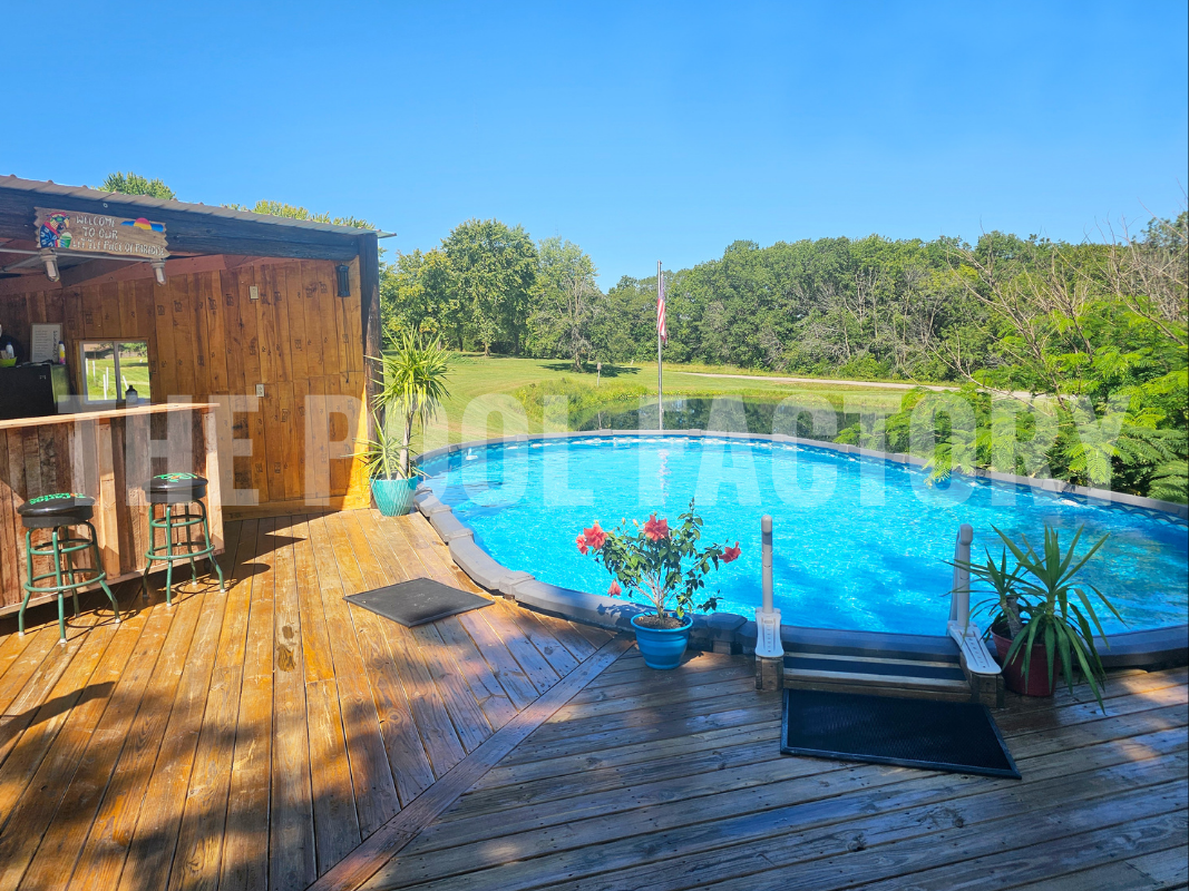 Saltwater oval swimming pool with outdoor bar and partial deck