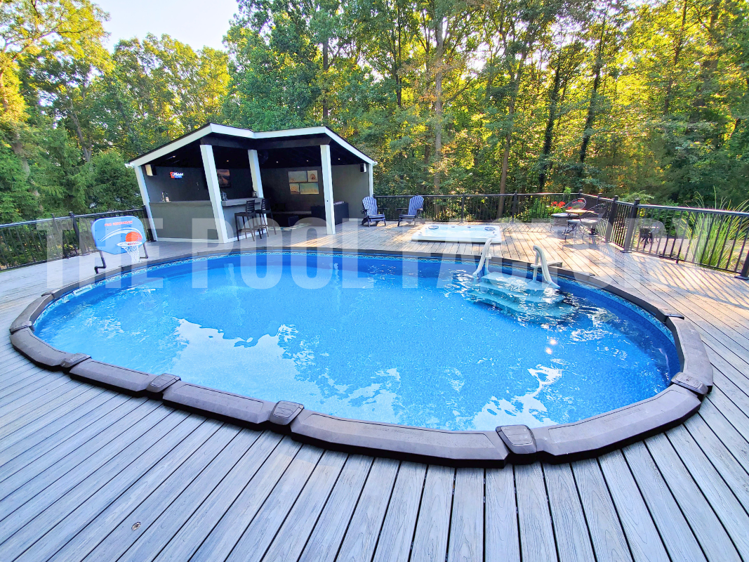 Semi inground oval swimming pool with full deck, outdoor bar and heated spa