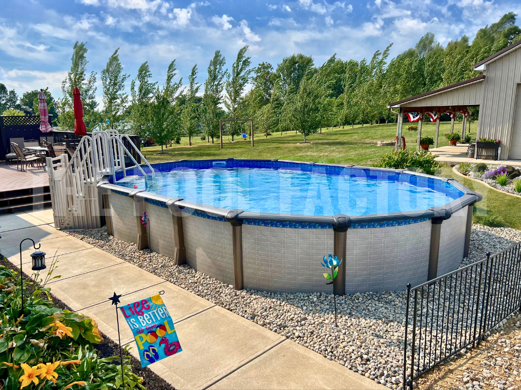 Oval swimming pool with decorative rocks on a sunny day
