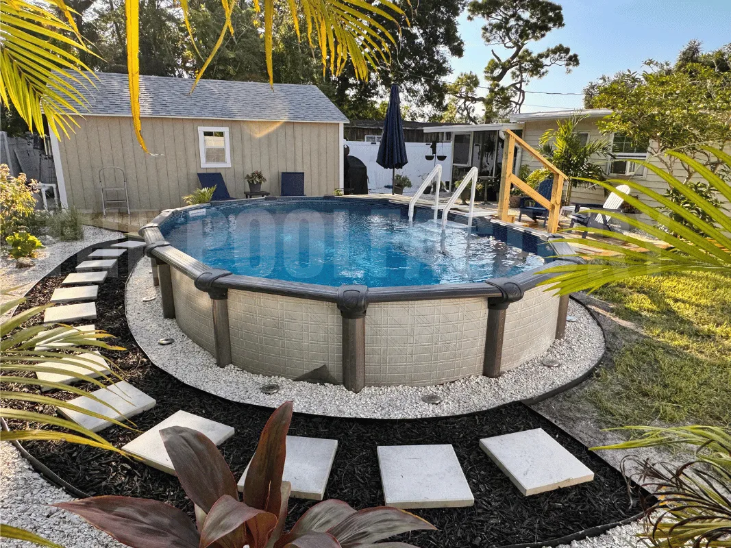 Above ground swimming pool with natural stone landscaping and garden path
