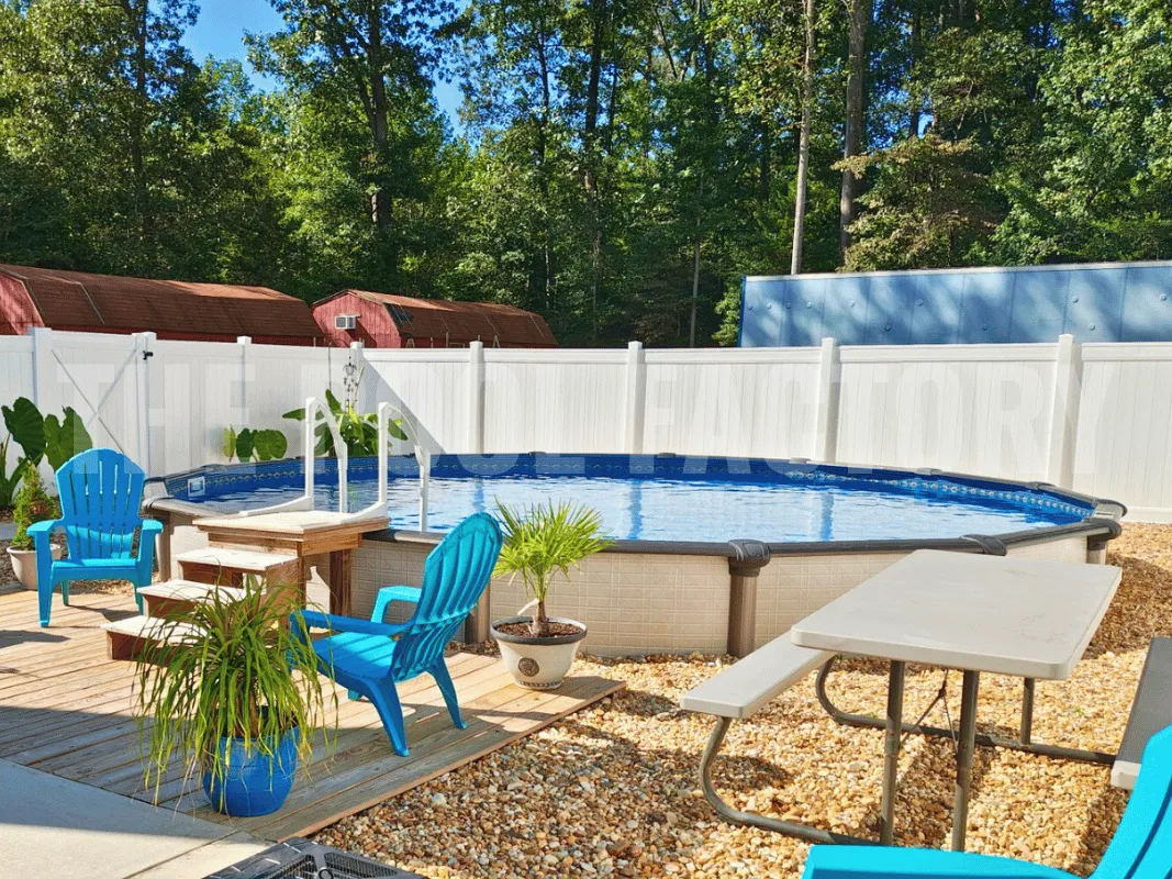 Round semi-inground swimming pool with pebble landscaping and lounge chairs