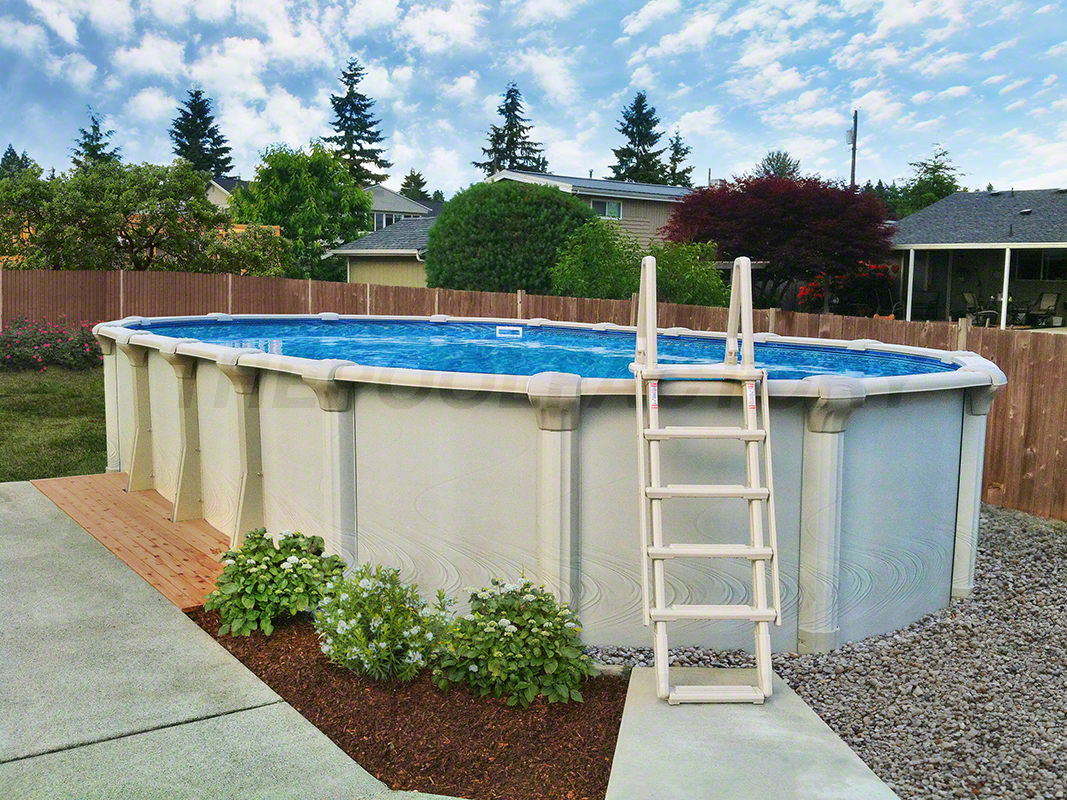Oval above ground swimming pool with surrounding stone landscaping