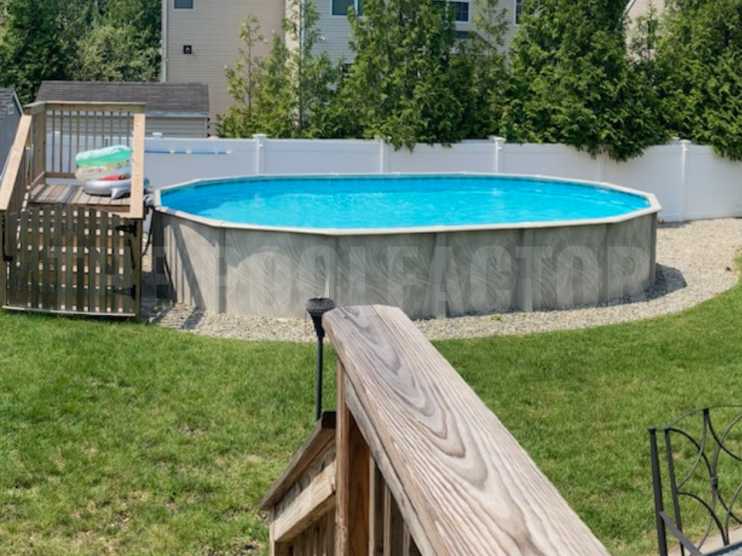 Oval above ground swimming pool with a small easy access deck in a suburban backyard