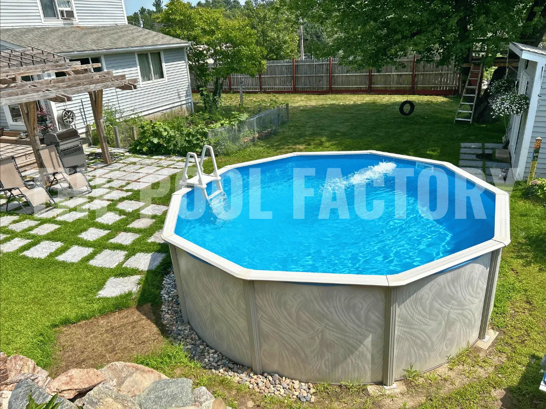 Round above ground pool surrounded by decorative landscaping including huge stone walkway and natural boulders