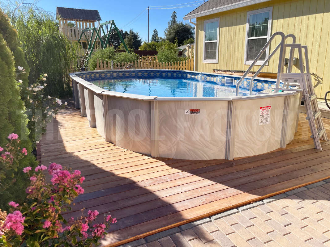 Above ground oval pool with lush flowers and beautiful landscaping