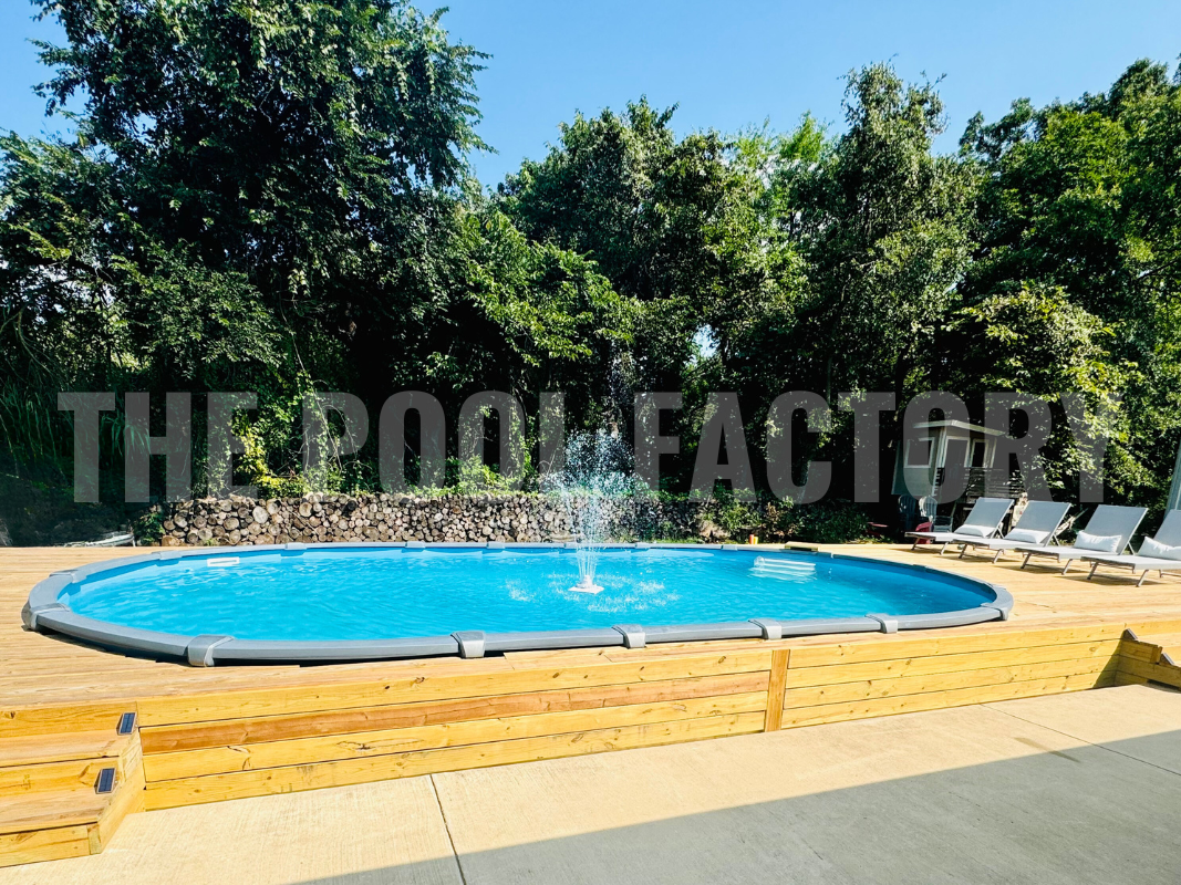 Semi-inground oval swimming pool with full deck and water fountain feature
