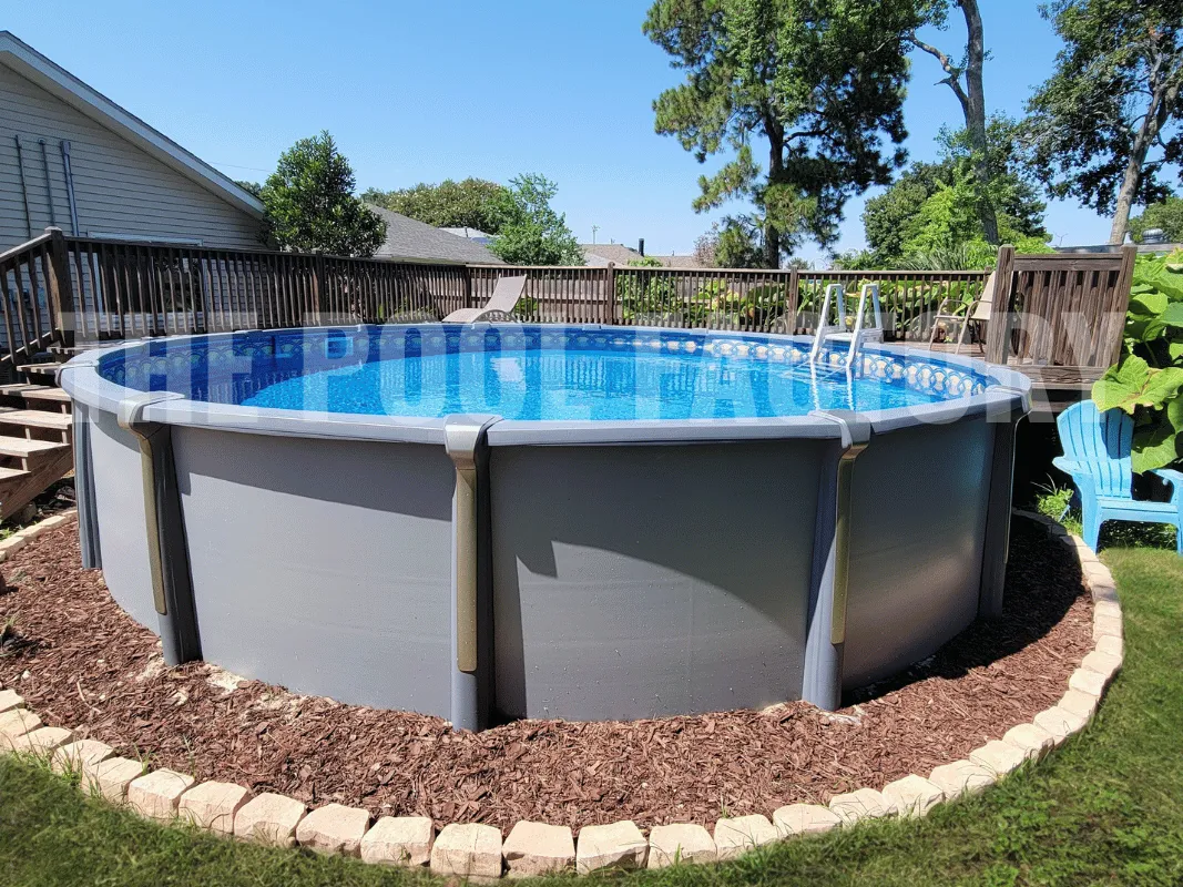 Round saltwater pool with nice stone border surrounded by mulch
