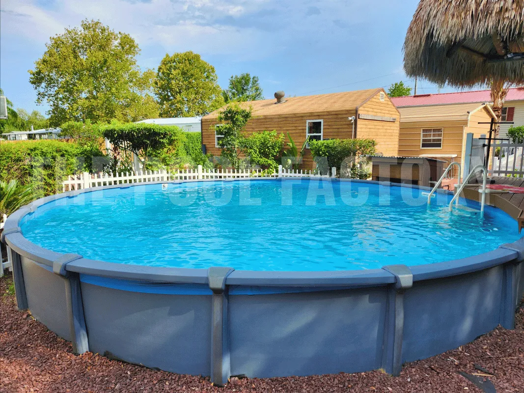 Round semi-inground pool surrounded by decorative mulch