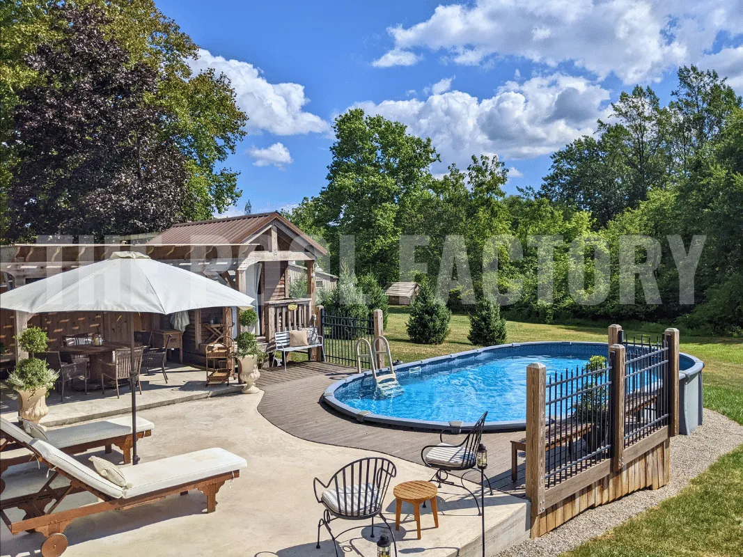 Oval semi-inground pool with Trex deck and surrounding concrete patio for outside furniture and lounge chairs 
