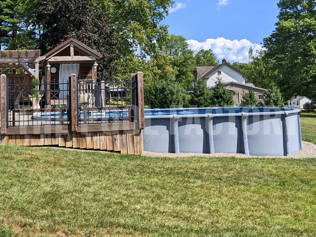Oval semi-inground pool with partial deck, grassy yard, and modern seating