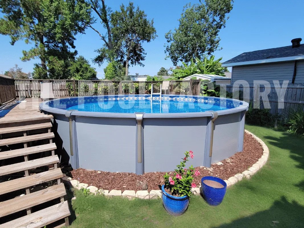 Round saltwater above ground pool with mulch landscaping and wood deck
