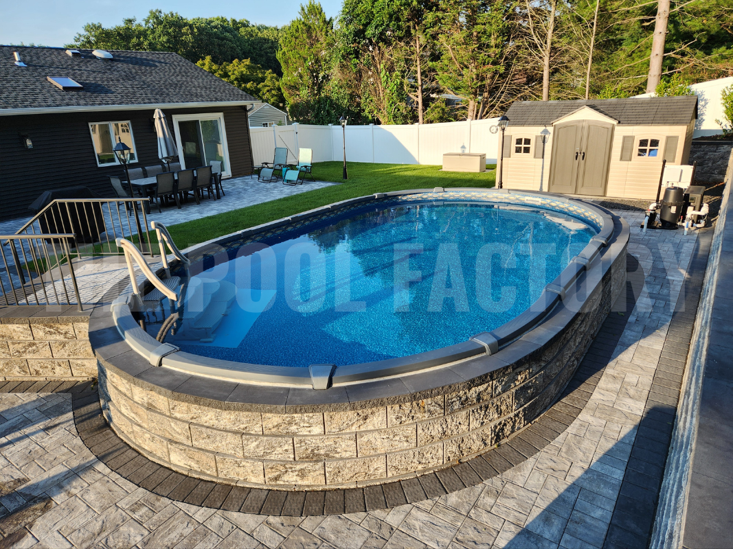 Oval semi-inground pool with a stone patio and stonework surrounding