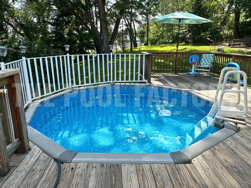 Backyard round above ground swimming pool with umbrella, deck, and safety fence kit