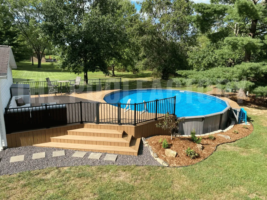 Round above ground swimming pool with partial Trex deck and railing
