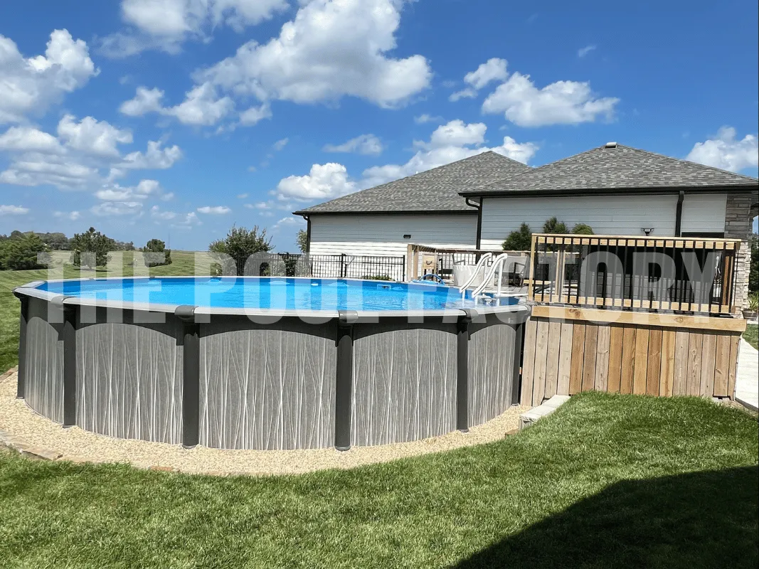 Round above ground pool with natural wood deck and surrounding green grass