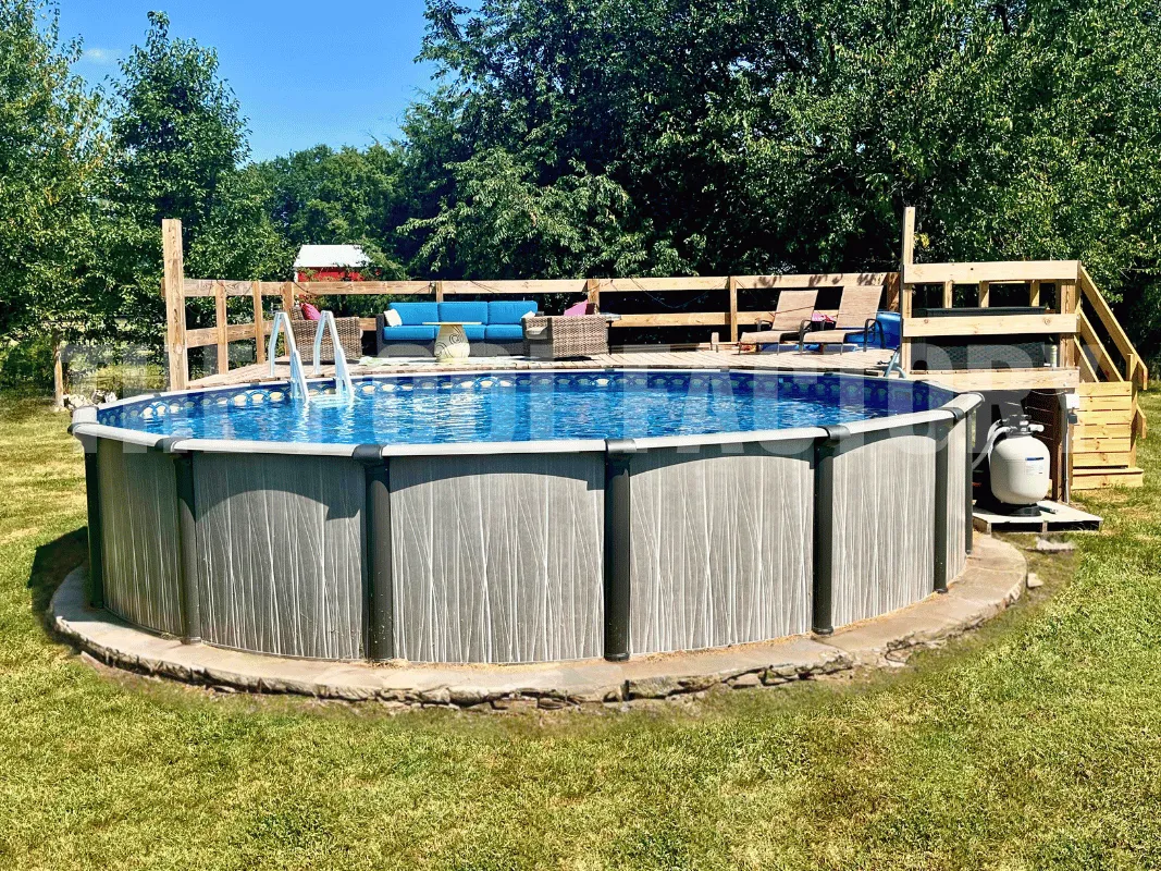 Round above ground pool with durable wood deck, steps, and railing