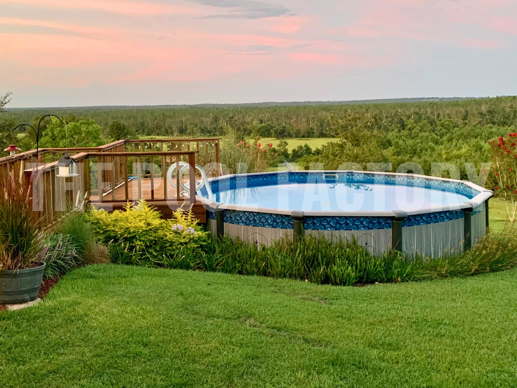 Above ground swimming pool with partial deck and lush greenery surrounding