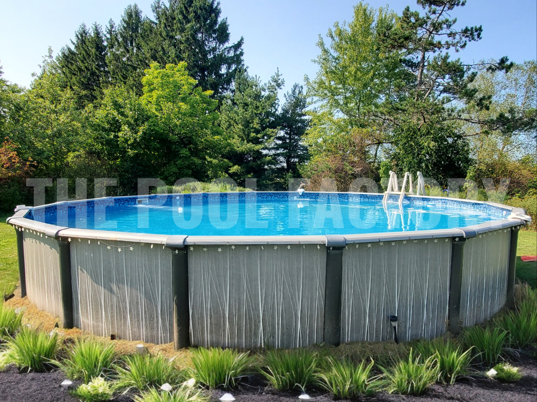 Above ground round swimming pool surrounded by trees, plants, and mulch