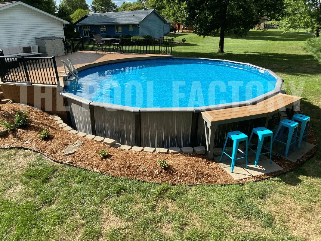 Round above ground pool with attached wooden deck and sitting area with counter space