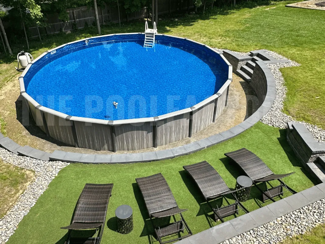 Round above ground swimming pool lounging area with sun patio chairs