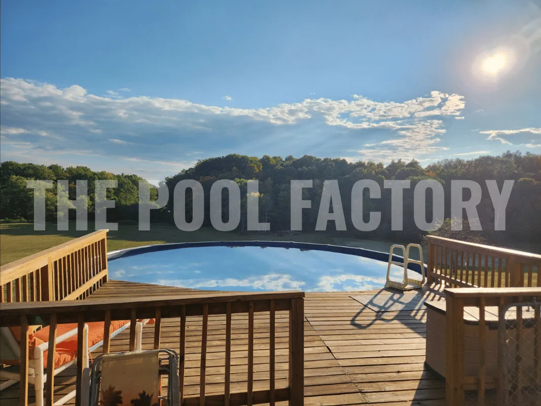 Above ground swimming pool with wood deck, lounging areas, and scenic backyard view