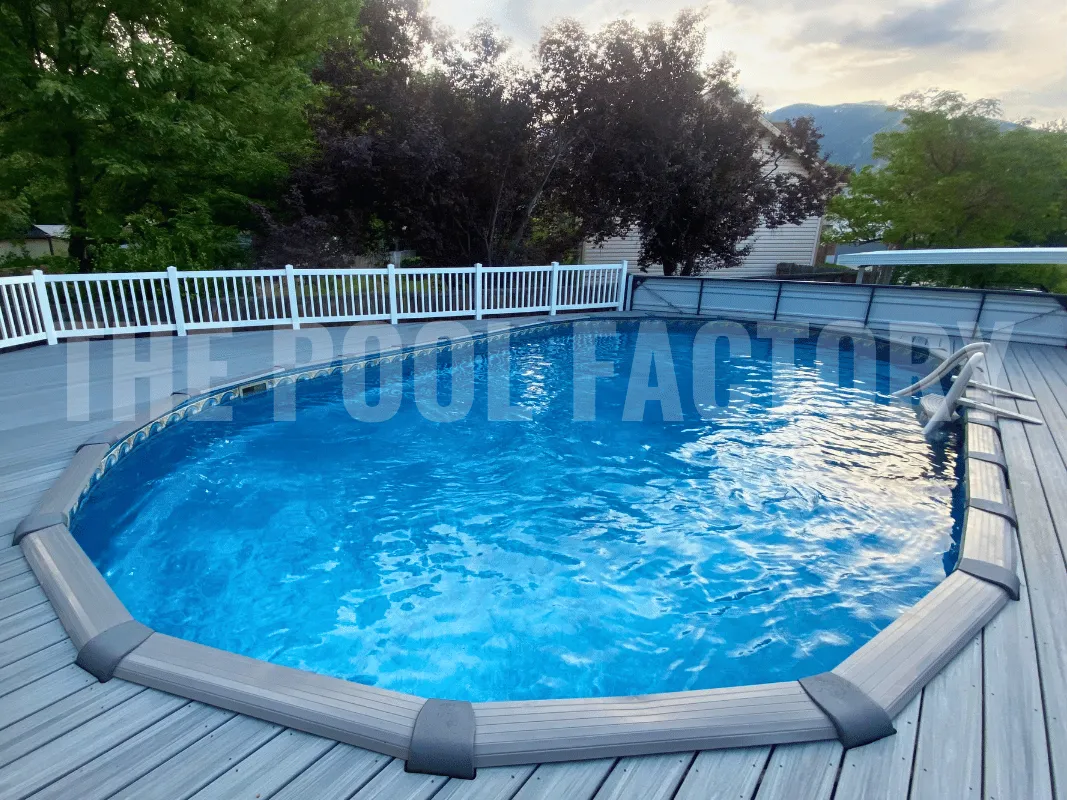 Oval above ground pool with full wraparound deck and railings
