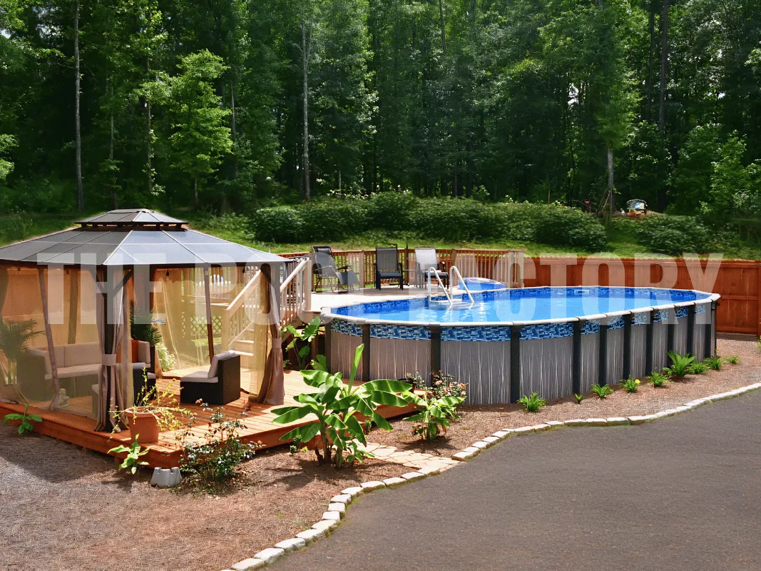 Oval shaped above ground pool beside deck patio with outdoor gazebo area