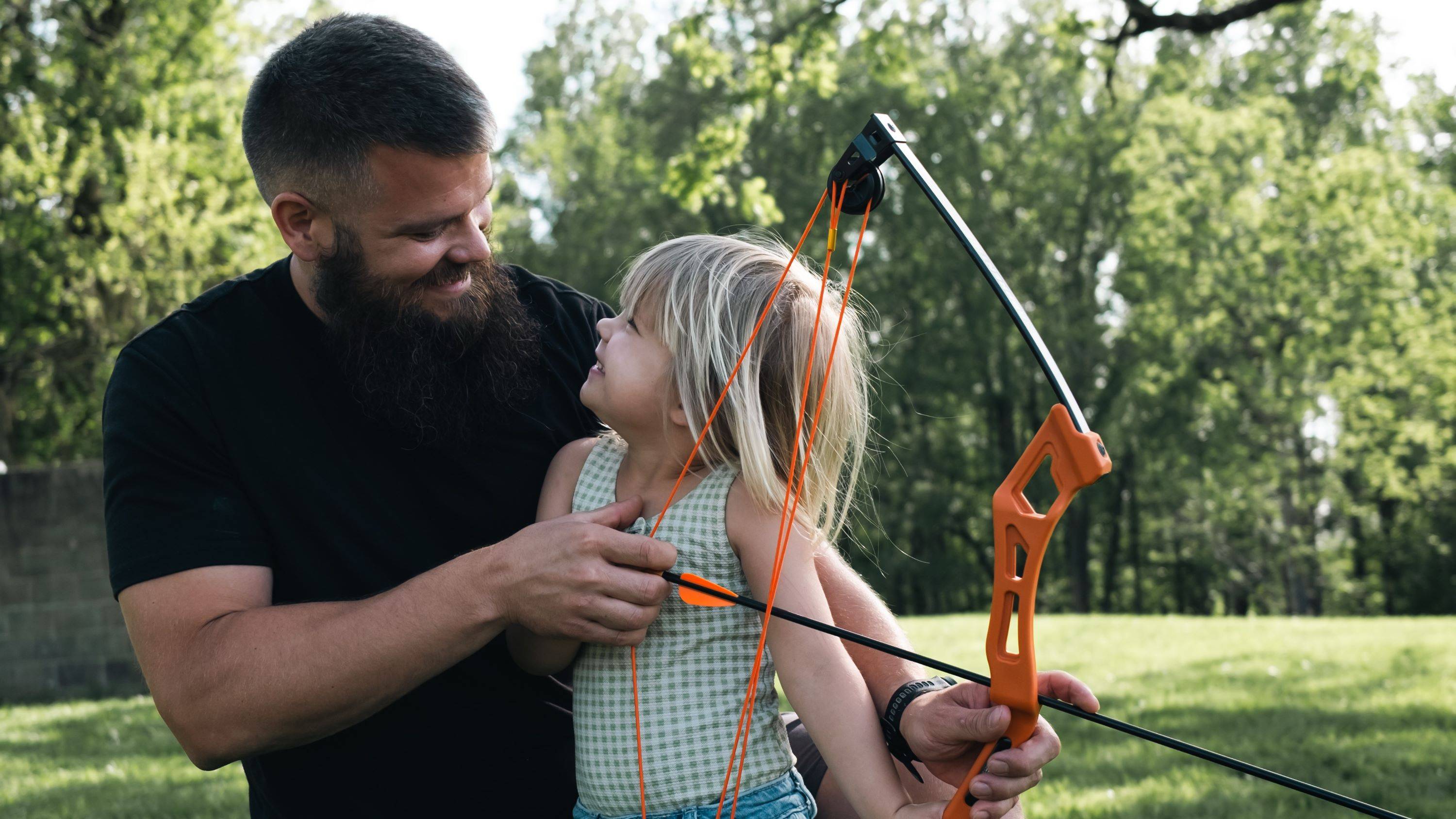 Dad and daughter holding the Bear Archery Apprentice youth bow