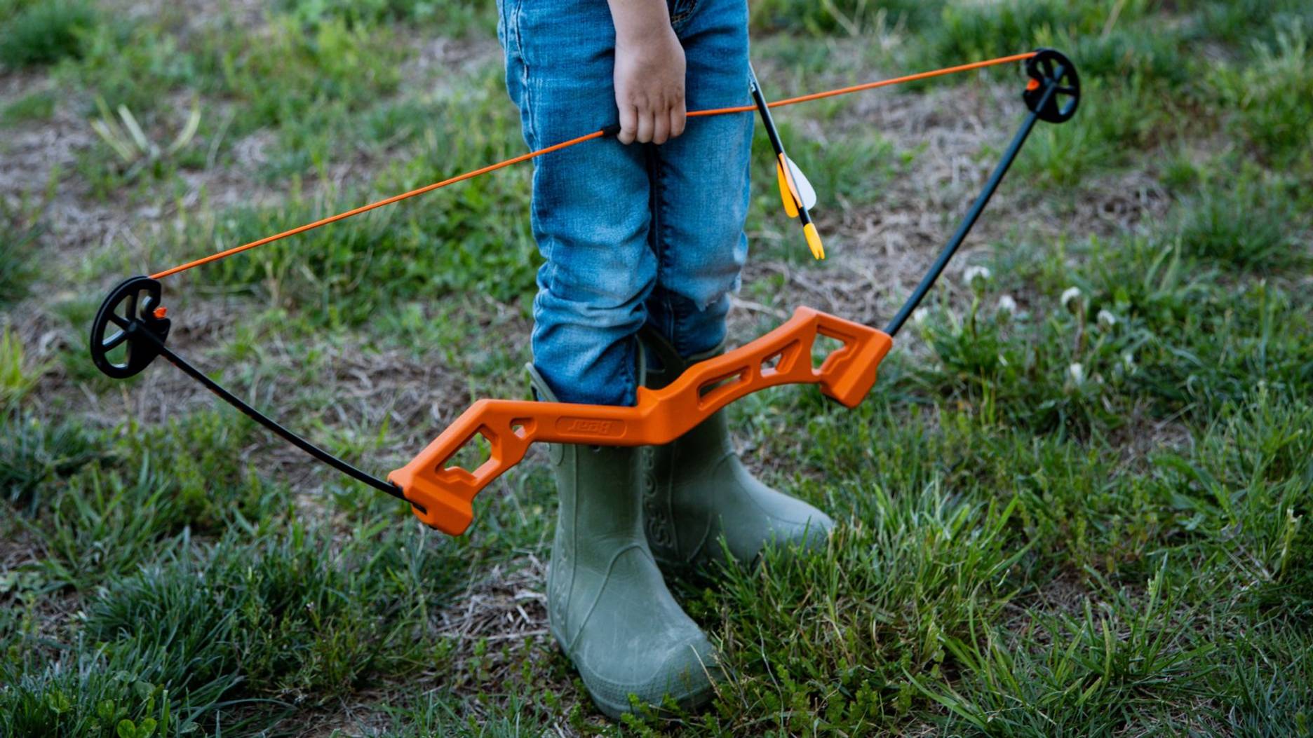 Close up of a child holding the Valiant youth bow from Bear Archery