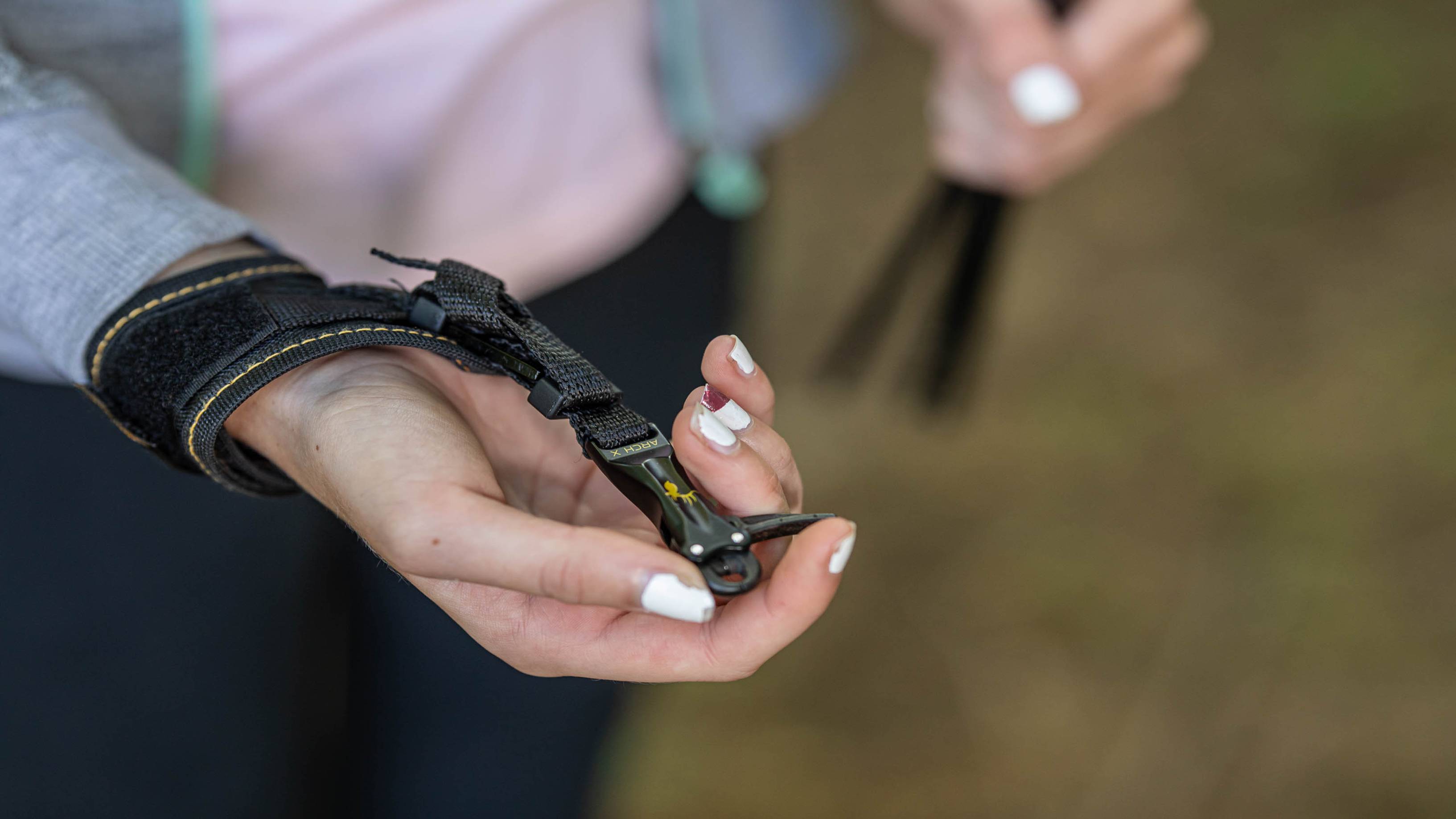Young girl holding the ArchX Youth wrist strap release from Trophy Ridge
