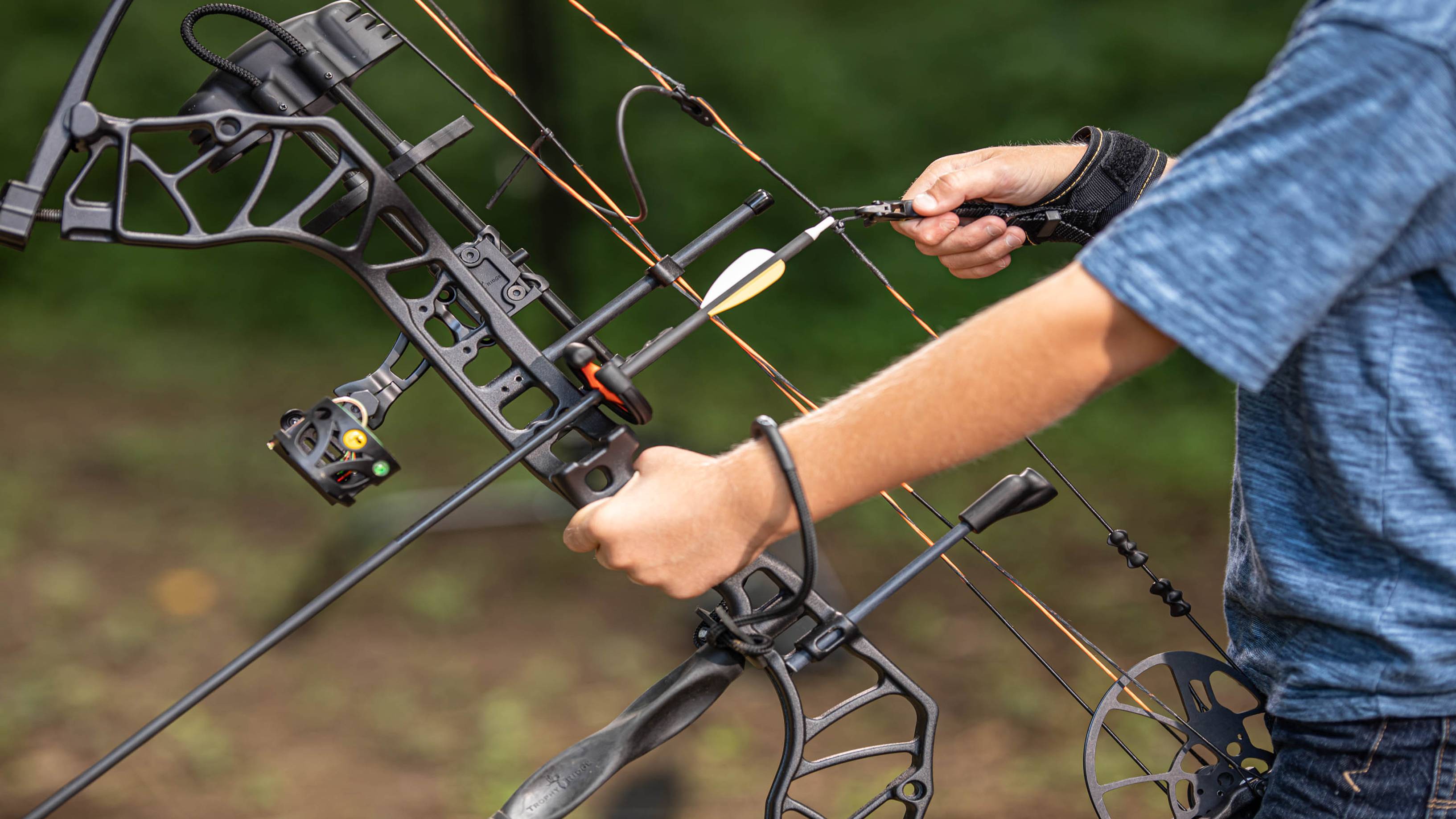 Young boy shooting a compound bow with the ArchX Youth wrist strap release from Trophy Ridge