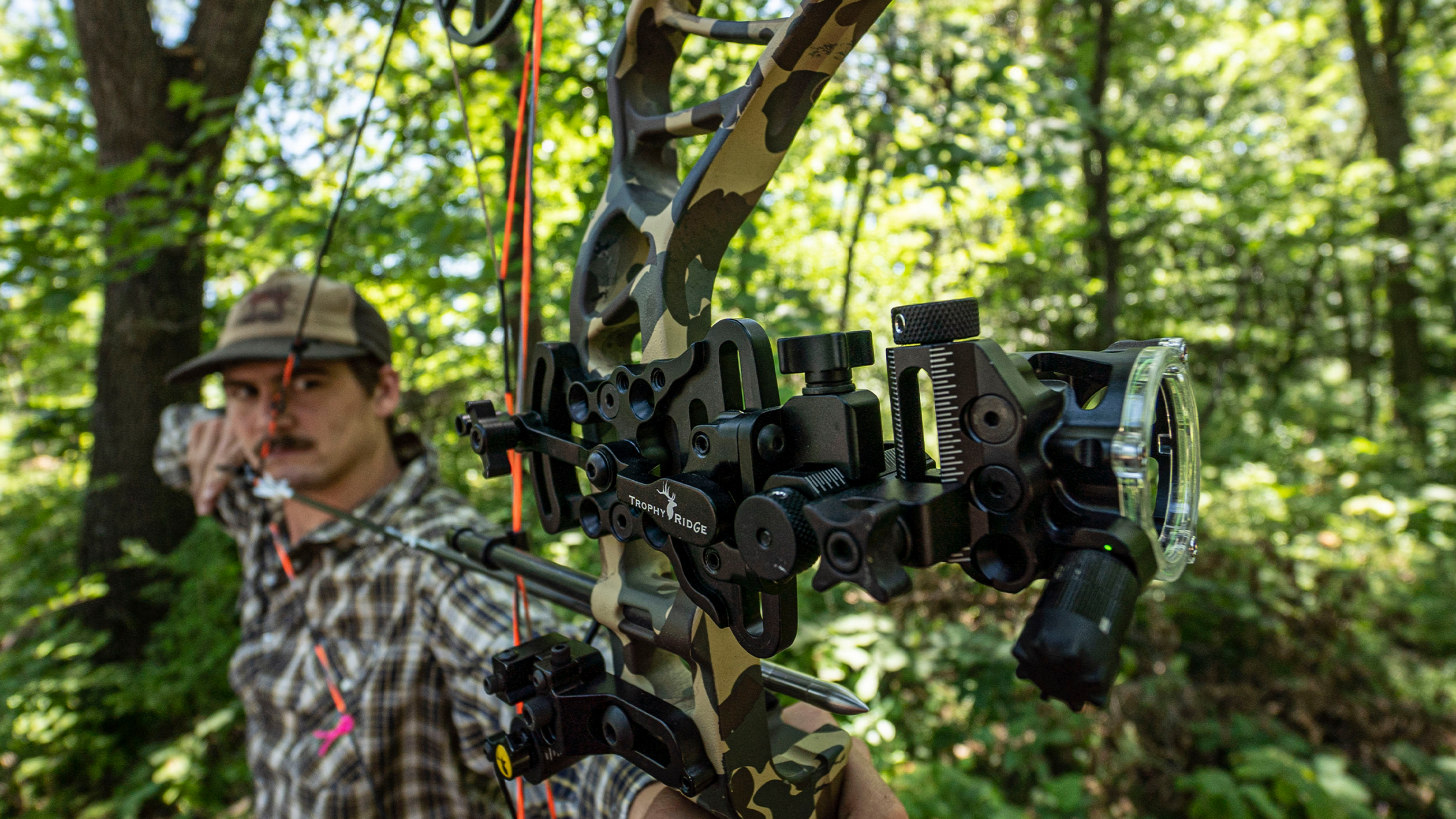 Man looking down bow through Trophy Ridge React® Alpha Bow Sight