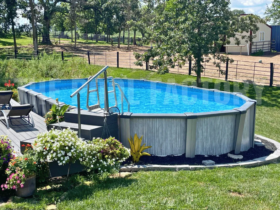 Serene backyard with oval swimming pool, partial wooden deck, and natural greenery