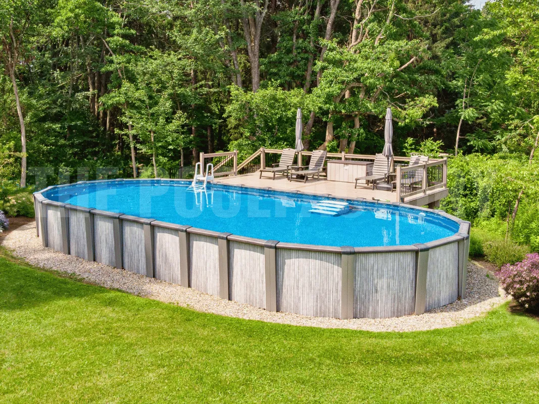 Oval above ground pool with beautiful landscaping and lush green grass