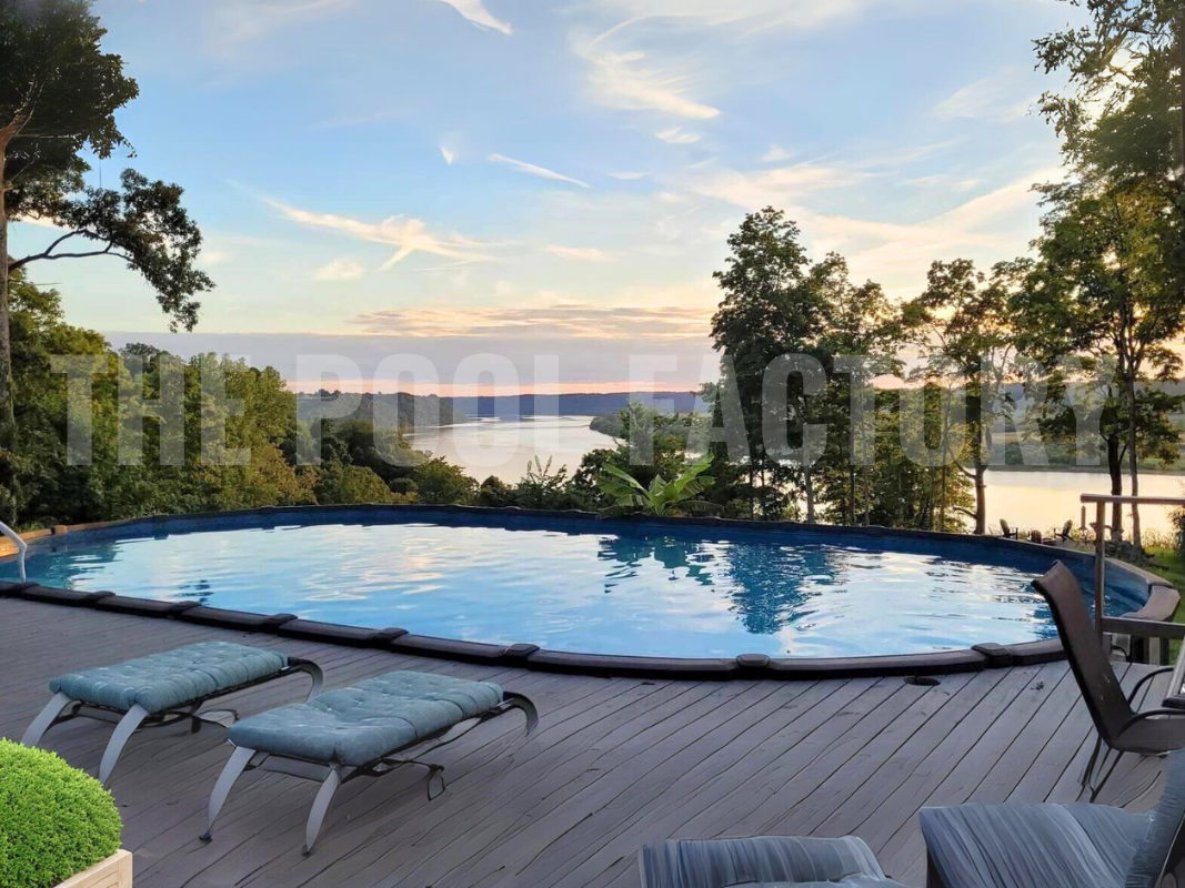 Oval saltwater swimming pool with deck, and lake backdrop