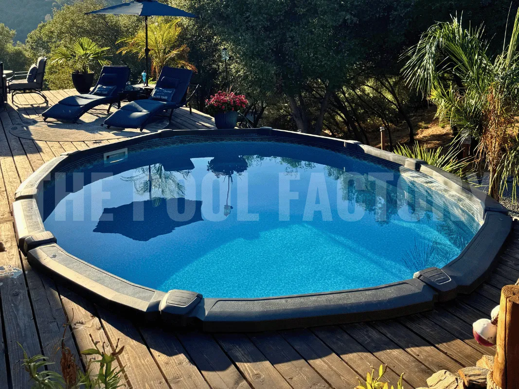 Oval above ground pool with modern deck design, loungers, and greenery surrounding