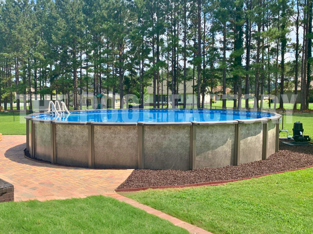 Round above-ground saltwater pool with a backdrop of tall trees