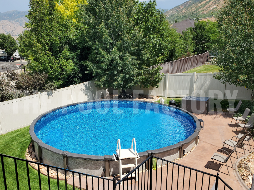 Round saltwater above ground pool with concrete patio and a sunny mountain view