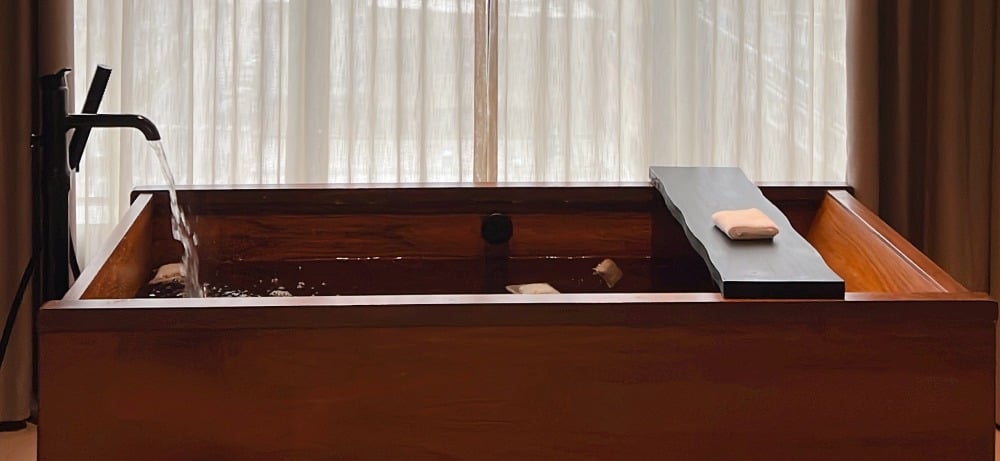 At-home spa aesthetic, wooden bath tub, mugwort bath ritual