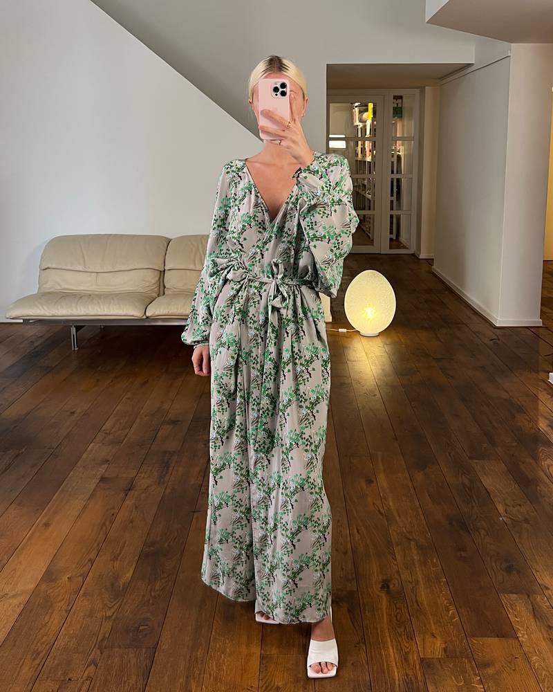 Bernadette Antwerp dress stella is a grey and green colored silk wrap dress, printed with in-house drawn flowers.  