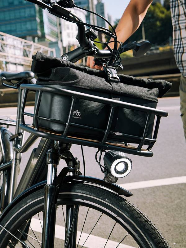 Close up view of a bag in a front basket attached to a black RadCity 5 Plus