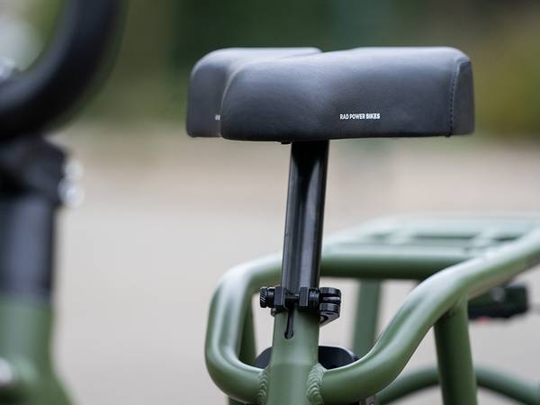 Close up a the cushioned seat on a green RadRunner 2 ebike