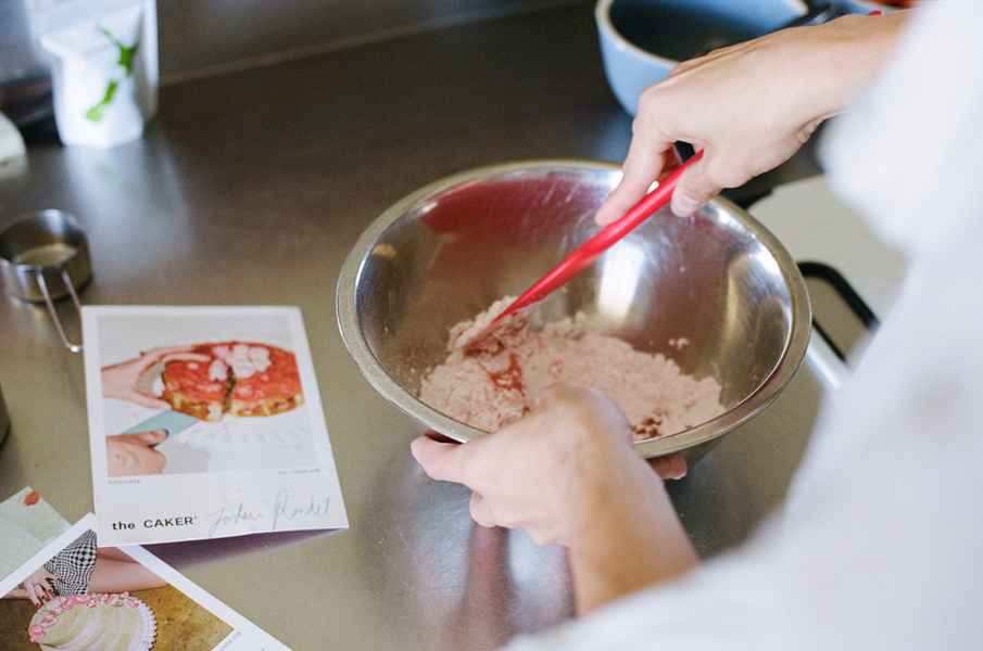 Lemon Strawberry Poppy Seed Cake KitEditorial Image of person making cake